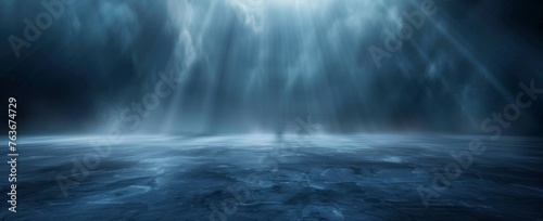 A dramatic interplay of light and shadow unfolds over a deep blue fog  reminiscent of the ocean s depths.