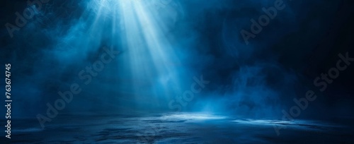 A dramatic interplay of light and shadow unfolds over a deep blue fog, reminiscent of the ocean's depths.