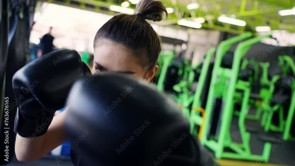 4K Confidence Asian woman athlete in sportswear with boxing gloves do workout exercise punching boxing bag at fitness gym. Healthy fit and firm woman do sport training and bodybuilding at sport club. 4K Confidence Asian woman athlete in sportswear with boxing gloves do workout exercise punching boxing bag at fitness gym. Healthy fit and firm woman do sport training and bodybuilding at sport club.