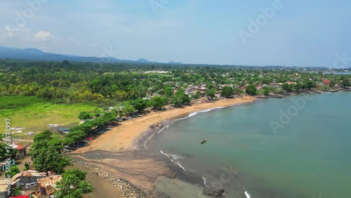 Aerial circular view of Melao beach, a beach known for being a large fishing village in Sao Tome,Africa photo