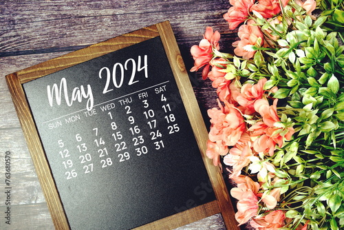 May 2024 monthly calendar with flower bouquet decoration on wooden background