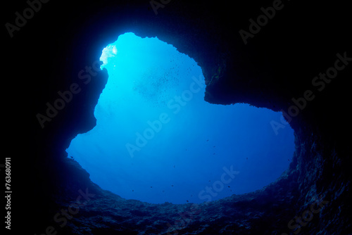 Looking up through the Blue Hole dive site from inside a lava tube along the cliffs of Guam