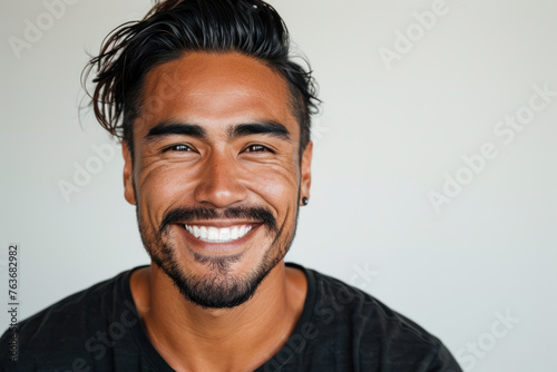 Smiling man with casual style on plain background. Positive human emotion.