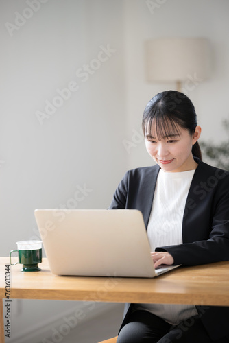 Japanese businesswoman operating a computer © kapinon