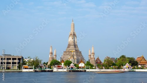 Pagoda at Wat Arun, a royal temple at Chaopraya river in Bangkok, Thailand. Time lapse video on a sunny day. photo