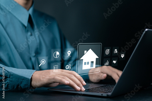 Real estate concept, property value, buy a house. Businessman use laptop with analyzing mortgage loan home and insurance real property mortgage.