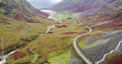 Aerial View Over Winding A82 Road Through Glencoe Valley Floor. Push Forward, Tilt Up Shot photo