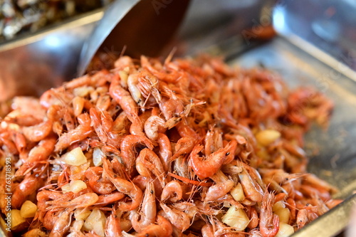 Market stalls sell crispy fried creek shrimps, a small freshwater delicacy known for its tender meat. This dish is deliciously crispy outside and tender inside, offering a delightful flavor.