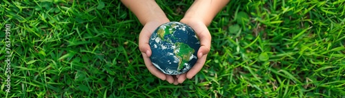 A young child holds a realistic Earth globe on a grass background shaped like a world map