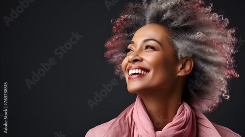 A smiling black adult woman with smooth healthy skin. Healthy, smiling, beautiful, mature woman with white teeth. Advertising concept for beauty, dentistry and skin care cosmetics