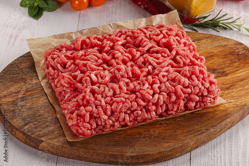 Raw minced beef meat over board