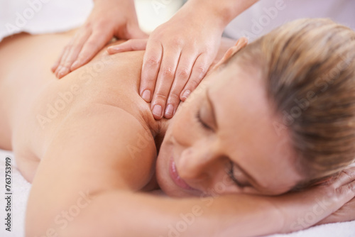 Woman, sleep and hands massage in spa, wellness and resting in hotel or lodge. Physical therapy, holistic and female person in holiday or vacation in California for health, peace and back skin detox