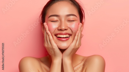 Serene portrait of a young asian woman with eyes closed and hands on face with copy space background