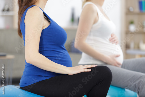 cropped image of pregnant women sat on aerobic balls