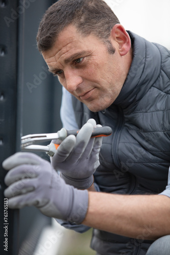 worker installs a window outdoors photo