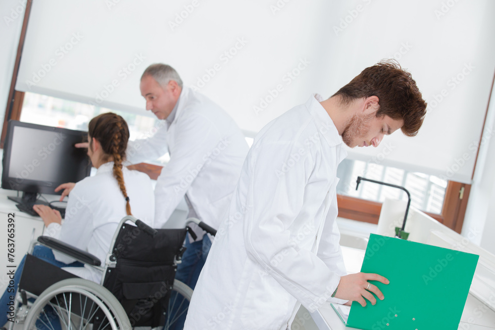 Students in science lab, one in wheelchair Students in science lab, one in wheelchair