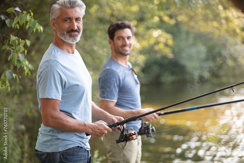 two male friends fishing in the lake