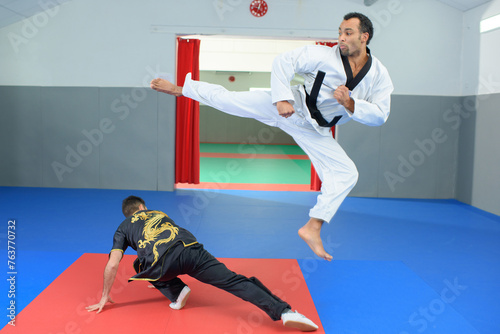 a man is doing a high kick photo