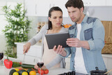couple with tablet template in kitchen