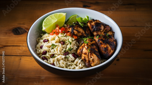 A bowl of spicy Jamaican jerk chicken with rice and pe
