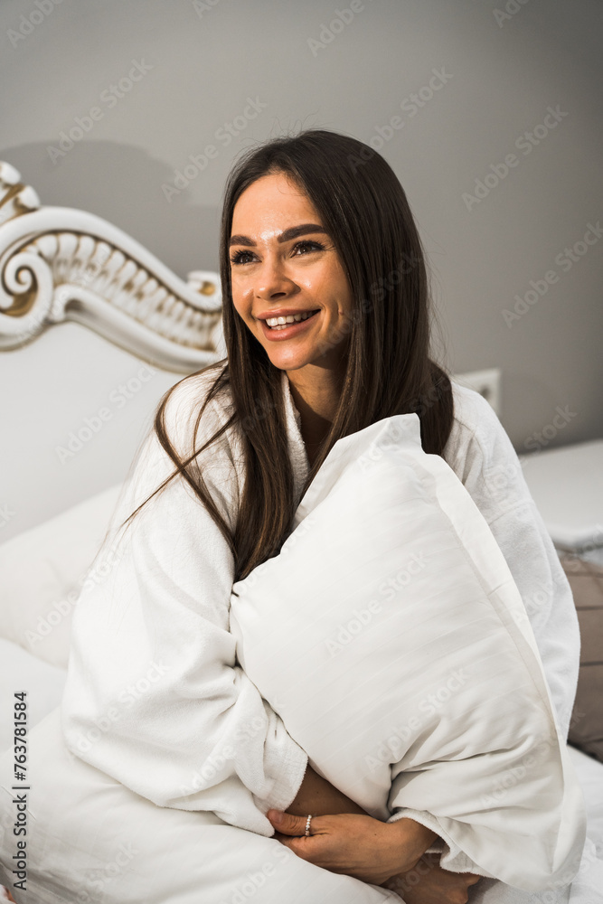 Young beautiful woman awaking in light hotel room.Morning of a happy woman.Hotel holiday concept Young beautiful woman awaking in light hotel room.Morning of a happy woman.Hotel holiday concept