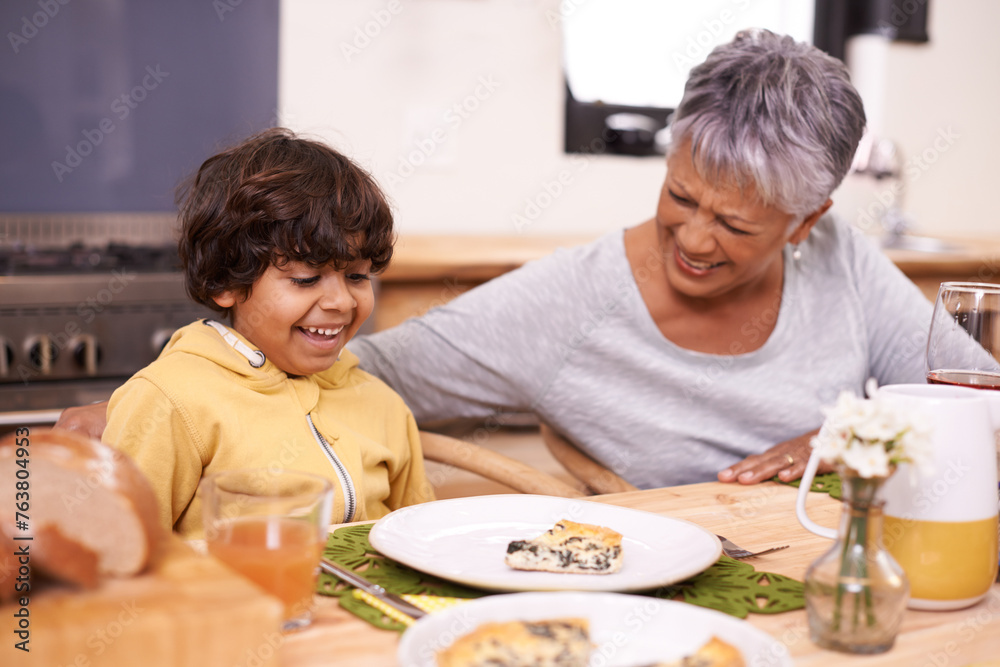 Happy grandmother, grandchild and food with family for thanksgiving, dinner or meal together at home. Grandma and little boy with smile at dining table in happiness for holiday weekend or bonding