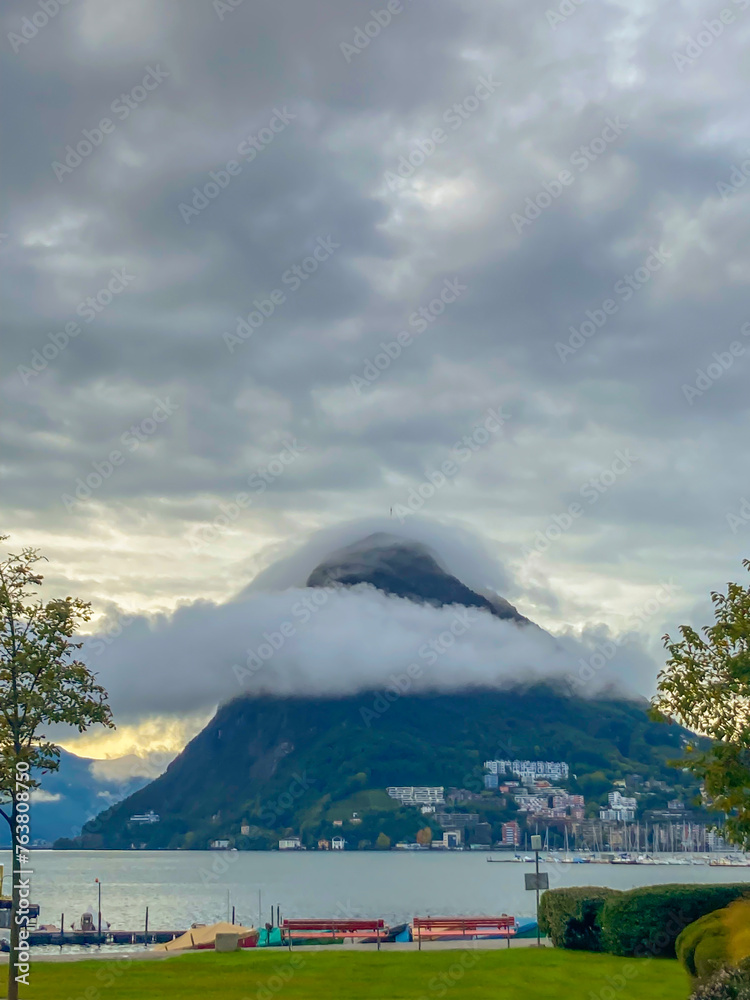 Mountain Peak (Monte Bre) Surrounded with Clouds and Lake Lugano in Ticino, Switzerland.