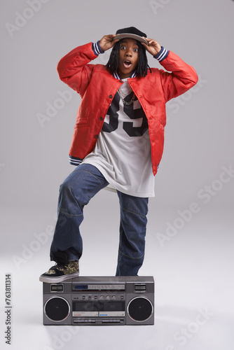 Child, hip hop and wow portrait with radio for music and rap in a studio with urban clothing. Fashion, African kid and boombox with trendy clothes and youth swag with confidence and grey background
