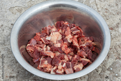 Fresh beef slices in a steel bowl. Beef is an excellent source of protein and supplies 10 essential nutrients including B vitamins, zinc, and iron that support an active and healthy lifestyle.  photo