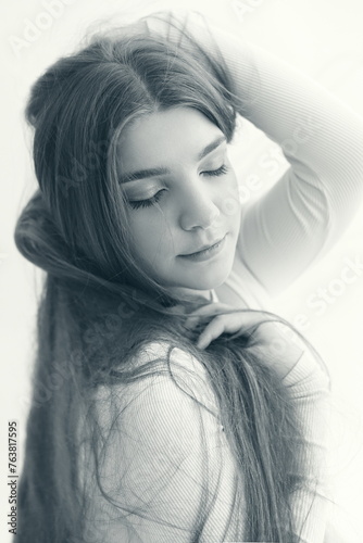 monochrome photograph of teenage girl with long hair painterly portrait