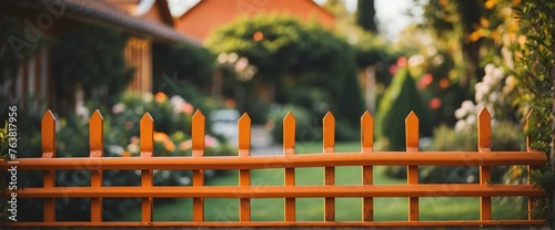 A orange metal picket fence on the side of the garden from Generative AI photo