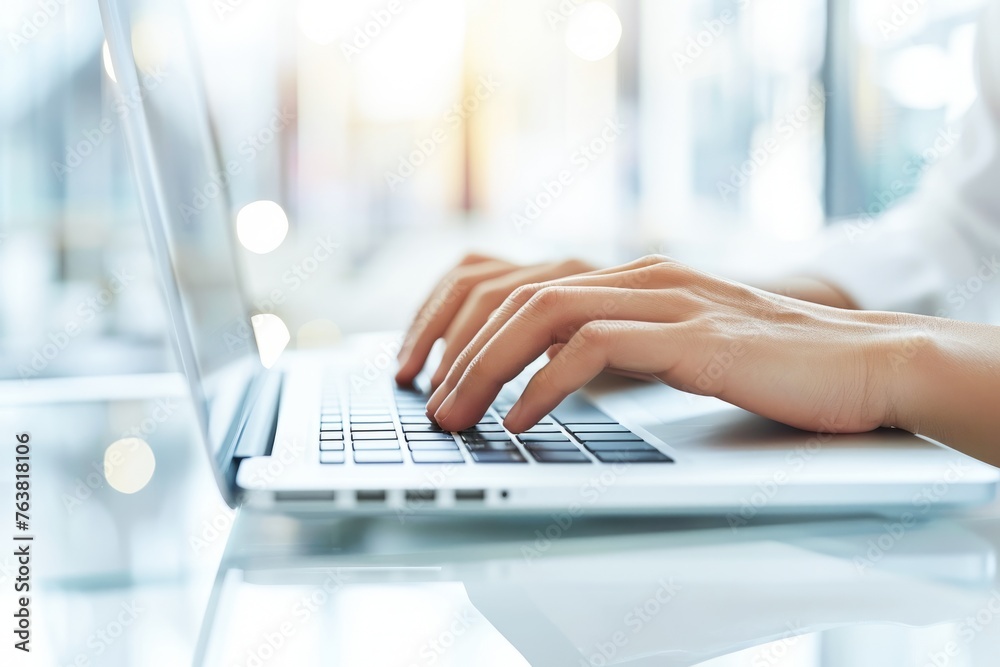 Professional Working on a Laptop in Modern Office During Daytime Professional Working on a Laptop in Modern Office During Daytime