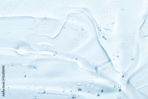 Fotografie The smear of a transparent gel on a blue background