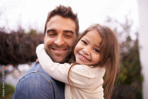 Hug, love and father carry girl for bonding, outside and family for quality time. Portrait, parent and young daughter with smile in nature, embrace and happiness for vacation or travel with dad