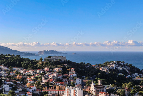 Panoramic view of Marseille from top Notre Dame de la Garde hill. City skyline with houses, streets and mountains, Marseille, France