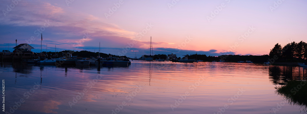 Cape Cod Sunrise Seascape Panorama at Quissett Harbor in Falmouth, Massachusetts, USA, a tranquil twilight coastal beauty with moored boats under warm pink dawn break