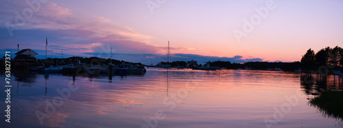 Cape Cod Sunrise Seascape Panorama at Quissett Harbor in Falmouth, Massachusetts, USA, a tranquil twilight coastal beauty with moored boats under warm pink dawn break © Naya Na
