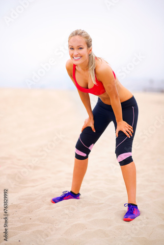 Woman, runner and portrait by beach, break and training for marathon in sportswear. Happy female person, outdoors and fitness for healthy body on sand, jog and cardio challenge for active workout