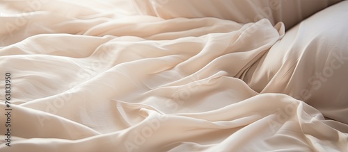 A close up of a bed with beige linens and wool pillows. The wood bedframe adds a rustic touch to the cozy bedroom decor