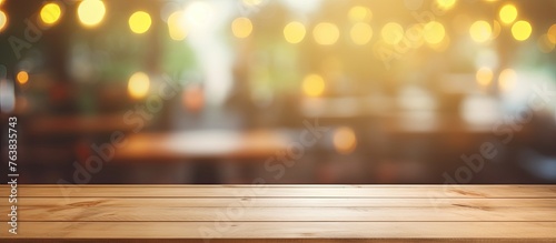 A hardwood table with tints and shades of amber wood, set against a blurry background of a bustling city restaurant. The horizon meets the sky as heat emanates from the wooden flooring