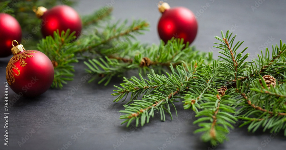 Festive Christmas tree branch adorned with ornaments, set on a dark table, signaling the holiday season. Festive Christmas tree branch adorned with ornaments, set on a dark table, signaling the holiday season.