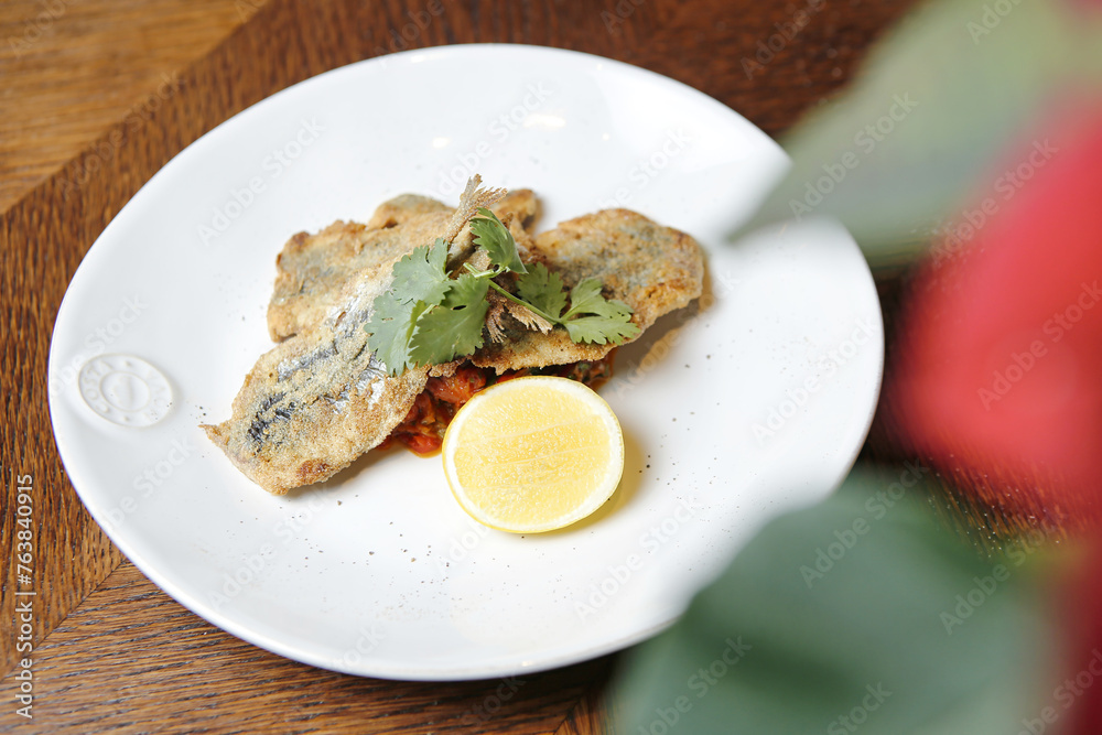 White Plate With Fried Fish and Lemon Slice