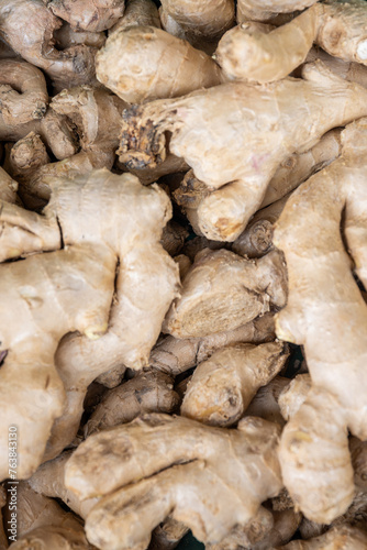 ginger roots,Background with ginger,root, fresh ginger root and ground ginger spice, close-up of ginger bulbs for sale in the market