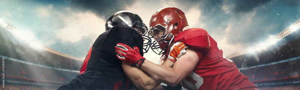 Two American football players in helmets confronting each other with intense expression, standing face to face on stadium with spotlights. Concept of professional sport, competition, tournament