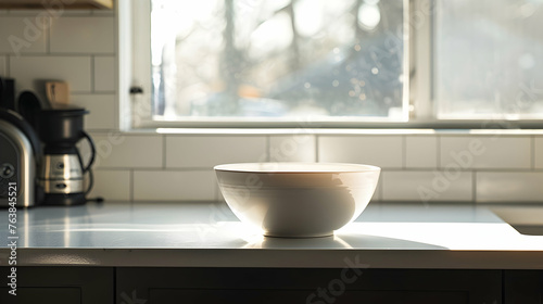 A white bowl is placed neatly on top of a kitchen counter creating a simple yet functional arrangement
