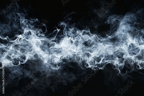 Whisps of delicate white smoke drift across a deep black background, creating a mysterious and ghostly effect.