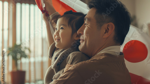 The Land of the Rising Sun: Father and Child Displaying the Japanese Flag
