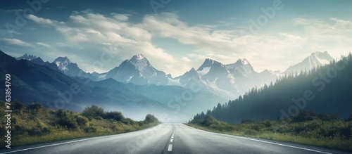 Road through mountains with clouds in the sky