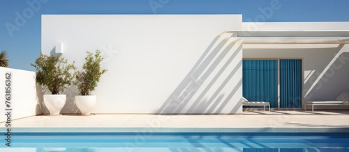 A pool with a blue door and white wall