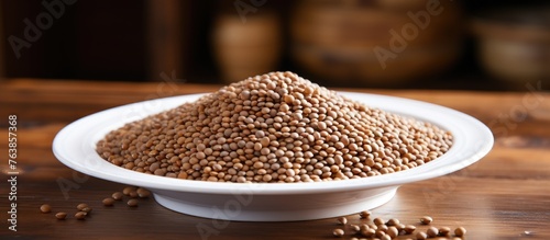 A white bowl of brown beans on wooden table